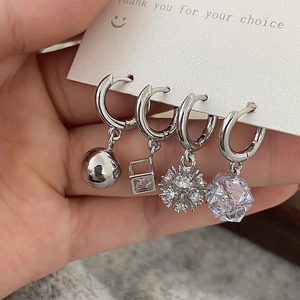 Silver hoop earrings set with sparkling zircon pendants in four geometric luxury styles