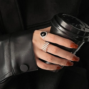 Cool silver open ring set with black gemstone on model in dark fashion style