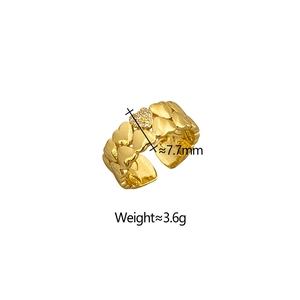 Detail of a gold open ring featuring double heart motifs and sparkling zircon inlay