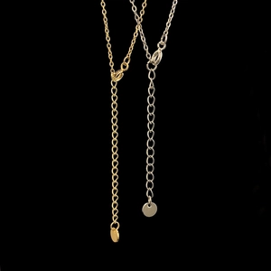 Detail of adjustable gold and silver chain extenders with lobster clasps and round tags