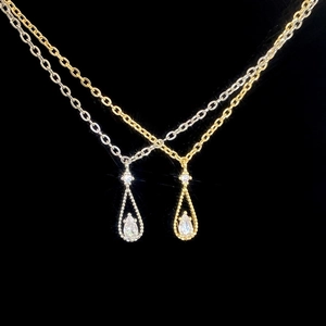 Detailed view of teardrop pendant necklaces with pear-cut zircon in gold and silver finishes