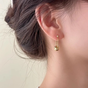 Minimalist gold tassel drop earrings featuring a polished ball stud and knotted ring pendant