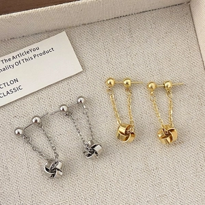 French style gold and silver tassel earrings with elegant metal knot pendant design