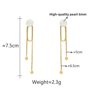 Detail view of 7.5cm long tassel earrings with 6mm pearls and golden chain pendants