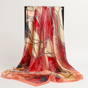 Grand foulard soyeux avec imprimé chaîne paisley rouge drapé sur un support minimal