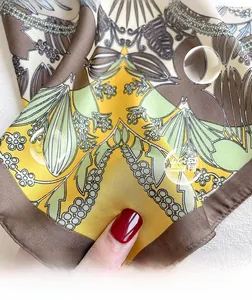 Detailed macro view of high-quality floral print silk scarf with a smooth, glossy texture