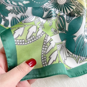 Green silk-like floral square scarf with elegant leaf print and hand-stitched rolled edges