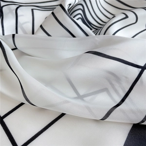 Macro detail of high-quality white silk scarf with minimalist black geometric lines texture