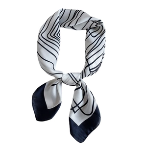 Elegant black and white geometric silk scarf with minimalist lines in a knotted display