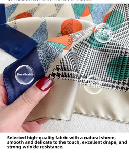 Detail of silk-like scarf featuring paisley, houndstooth and colorful polka dot patterns