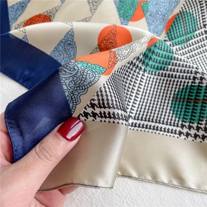 Macro detail of silk-like scarf with paisley, polka dot and houndstooth patterns