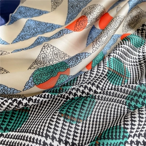 Detailed macro shot of silky scarf fabric with paisley print and houndstooth texture