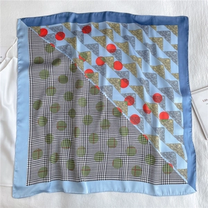 Detail of square silk scarf with houndstooth and polka dot geometric patterns