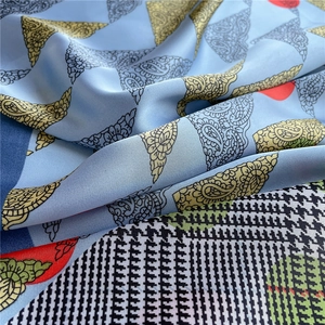 Detail of light blue silk scarf showing baroque paisley patterns and houndstooth texture