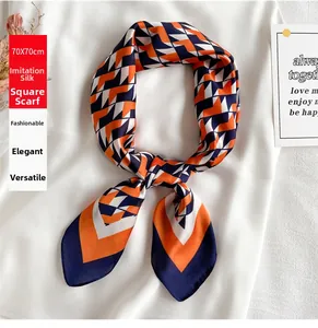 Detail of 70x70cm faux silk scarf with orange and navy geometric triangular patterns
