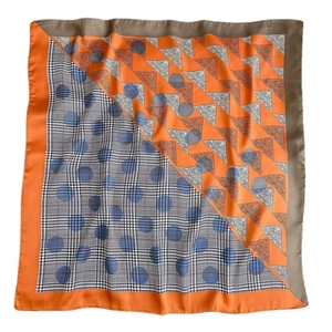 Silk-like square scarf featuring geometric houndstooth and paisley print in orange and blue