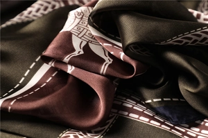 Detail of soft satin scarf with vintage horse print and smooth silk texture
