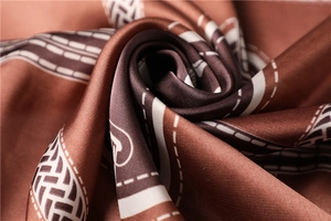 Macro detail of silk scarf texture with brown geometric patterns and smooth soft folds