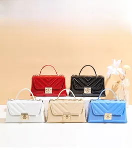 Close-up of elegant small square bags with V-shaped quilting and gold metal twist locks