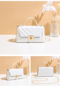 Close-up of white V-quilted crossbody bag featuring a gold handle and twist-lock clasp