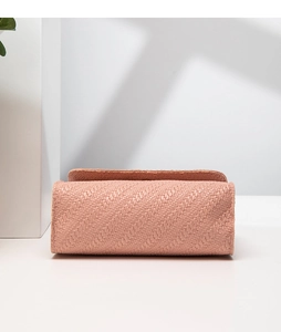 Close-up of pink woven crossbody bag showing detailed twill texture and stitching craft