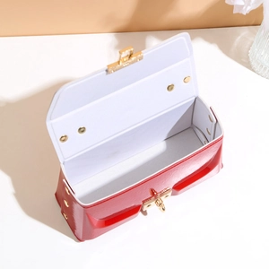 Elegant red patent leather crossbody bag with gold twist lock and interior storage