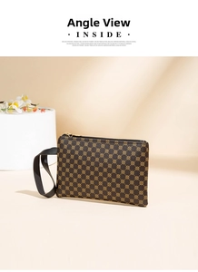 Detail of retro water ripple pattern handbag with leather wrist strap and golden zipper