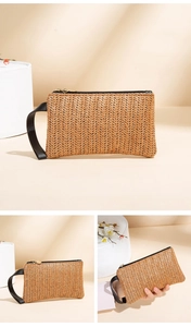 Detail of woven straw clutch bag showing natural V-pattern texture and black zip closure