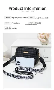 Detail view of black quilted crossbody bag with wide lettered strap and 18.5cm dimensions
