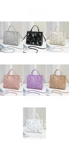 Detail showing seven color options of floral embroidered handbags with crossbody straps