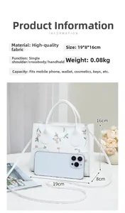 Detail showing white floral embroidered handbag with 19x8x16cm dimensions and strap