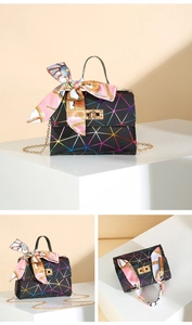 Detail of black crossbody bag with iridescent geometric print and silk scarf handle