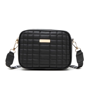 Quilted black camera bag with golden metal plate and patterned crossbody strap