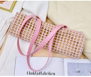 Detail of pink crochet shoulder bag showing woven texture and smooth leather strap