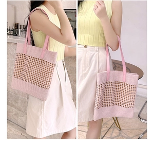 Macro detail of pink crochet woven tote bag featuring hollow mesh and leather straps