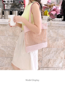 Detail of pink hand-knitted crochet tote bag with mesh pattern and leather handles