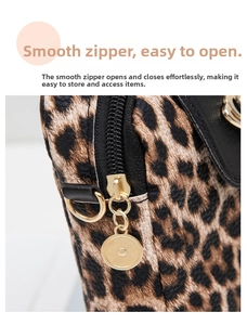 Detail of smooth gold circular zipper puller on leopard print textured handbag