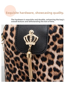 Detail of leopard print crossbody bag featuring a golden crown buckle and metal tassels