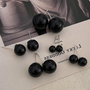 Macro detail of S925 sterling silver black pearl stud earrings in various sizes