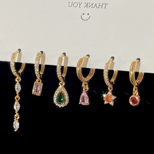Detailed view of six gold-plated tassel earrings set with colorful multi-shape zircons