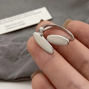 Minimalist silver open ring with flat oval ends shown on hand with a high mirror finish