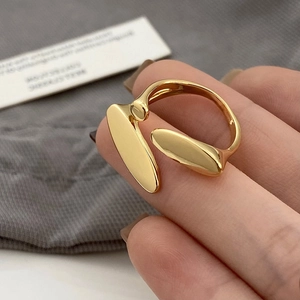 Detailed shot of an adjustable 18K gold-plated minimalist capsule-style open ring