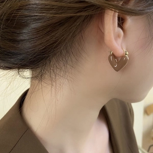 Elegant dark coffee heart-shaped drop earrings with gold metal rings on a model