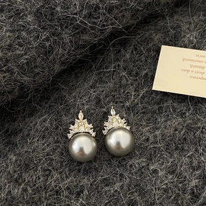 Macro shot of crown pearl earrings with grey pearls and pavé cubic zirconia