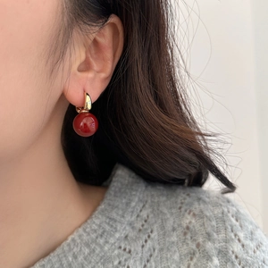 French style red pearl earrings with golden hoops on model for festive look