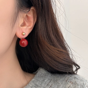 French style red pearl earrings with gold studs worn by model in a vintage aesthetic