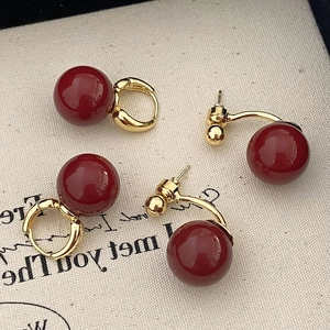 French style red pearl earrings in gold plating with festive vintage design on canvas