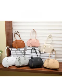 Litchi pattern handbags in seven colors including brown, pink, and black on display