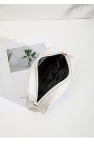 Top view of mini square bag showing black nylon interior and white floral PU material