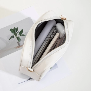 Off-white embroidered floral crossbody bag with gold hardware and interior storage space